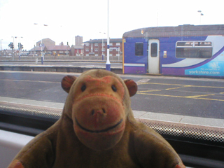 Mr Monkey inspecting a train from his train window
