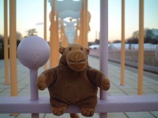 Mr Monkey sitting on ornate pink railings