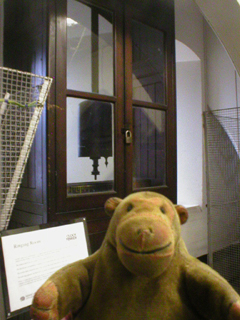 Mr Monkey looking at the pendulum of the Town Hall clock