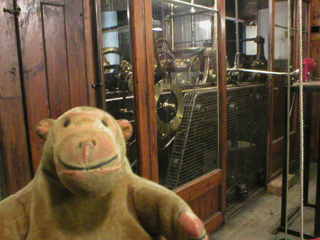 Mr Monkey looking at the mechanism of the Town Hall clock
