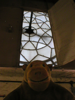 Mr Monkey looking at the back of one of the clock faces