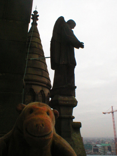 Mr Monkey looking at an angel at the top of the clock tower