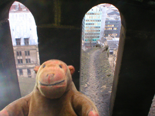 Mr Monkey examining a gargoyle at the top of the clock tower