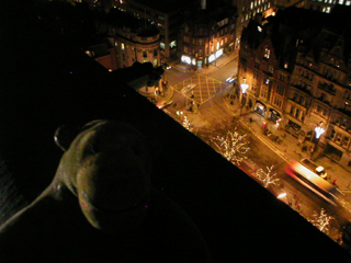 Mr Monkey looking down on Albert Square from the clock tower at night