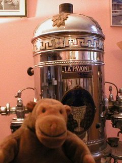 Mr Monkey in front of a large coffee machine