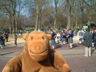 Mr Monkey in front of a pipe band