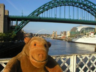 Mr Monkey on the swing bridge, with the Tyne bridge behind him