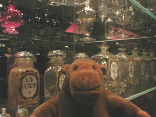 Mr Monkey in front of a case of bottles