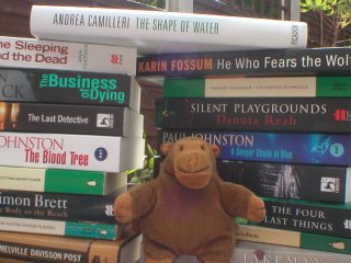 Mr Monkey with a pile of books