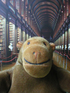 Mr Monkey in front of a picture of the Long Room