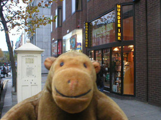 Mr Monkey outside Murder Ink, the crime book store