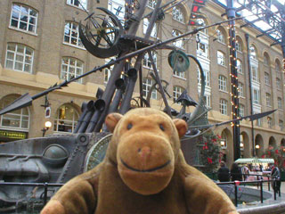 Mr Monkey in front of an abstract shipping sculpture