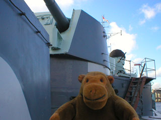 Mr Monkey beside the front turrets of the Belfast
