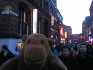 Mr Monkey in the crowds on the corner of Nicholas and Faulkner Streets
