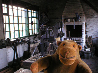 Mr Monkey inside the cobbler's shop