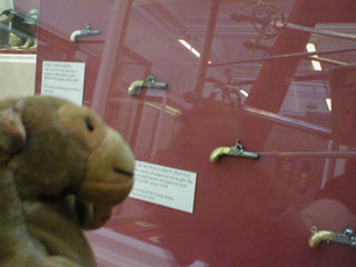 Mr Monkey looking at minature firearms