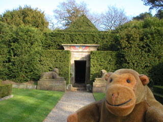 Mr Monkey approaching a yew-covered Egyptian temple