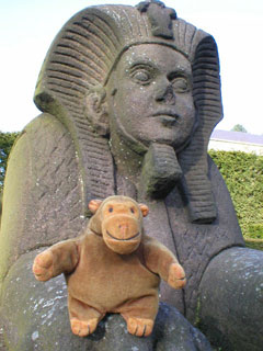 Mr Monkey sitting on the paw of a sphinx