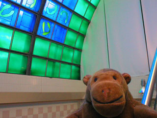 Mr Monkey on the stairs under the blue and green roof