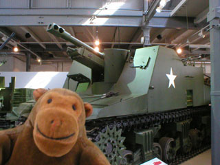 Mr Monkey in front of a Sexton self-propelled gun