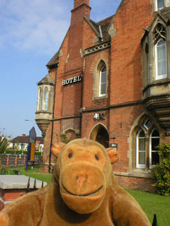 Mr Monkey in front of the Corner House hotel