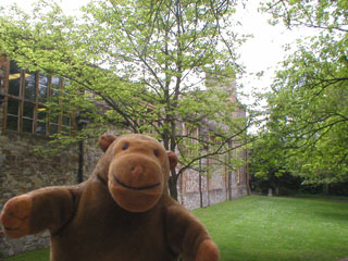 Mr Monkey beside a castle wall
