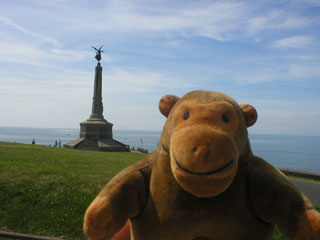 Mr Monkey with the war memorial behind him