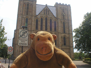 Mr Monkey in front of the west face of Ripon Cathedral