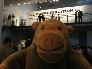 Mr Monkey looking up at the Ill Communication II sign