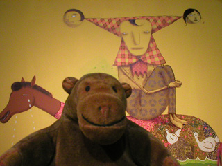 Mr Monkey examining the Os Gemeos person sitting on a horse