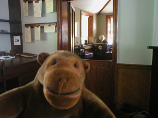 Mr Monkey looking through the main office to manager's office