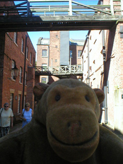 Mr Monkey between two mill buildings