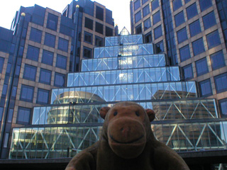 Mr Monkey infont of ornate glass front buildings