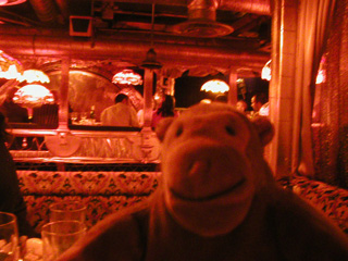 Mr Monkey in a booth in a restaurant