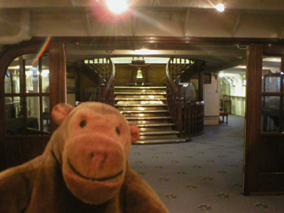 Mr Monkey looking at a fine staircase aboard the Wellington