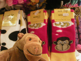 Mr Monkey examining socks decorated with a monkey face and bananas