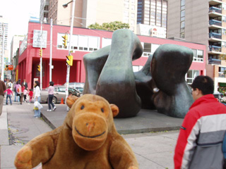 Mr Monkey looking at a Henry Moore sculpture outside the gallery