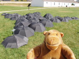 Mr Monkey with an installation made of black umbrellas