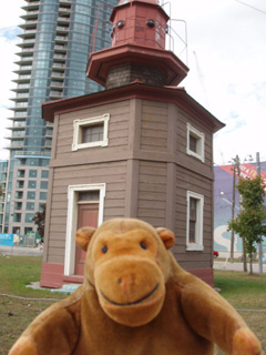 Mr Monkey in front of the Queen's Wharf Lighthouse