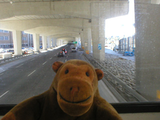 Mr Monkey on a bus under the Gardiner Expressway