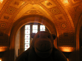Mr Monkey looking at the ceiling of the entrance hall from the mezzanine