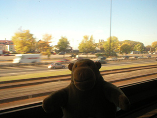 Mr Monkey in a train, beside the highway