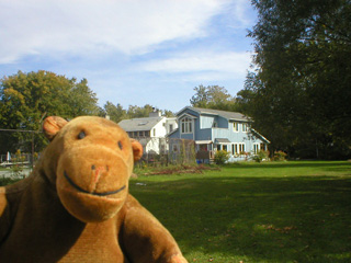 Mr Monkey with clapboard houses in the distance