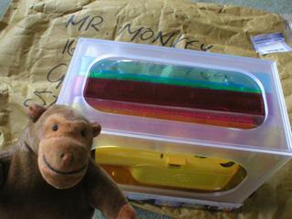 Mr Monkey opening a package containing a camera