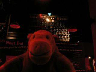 Mr Monkey in front of a theatre lighting panel