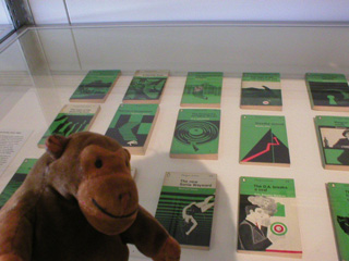 Mr Monkey examining Penguin crime books