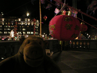 Mr Monkey looking at Chinese decorations in the dark