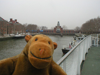 Mr Monkey looking at the old ferry terminal from the ferry