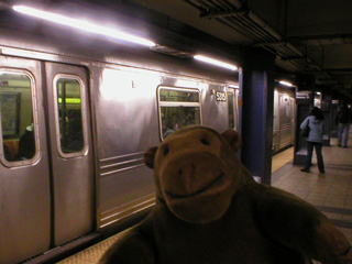 Mr Monkey waiting for a subway train to open its doors