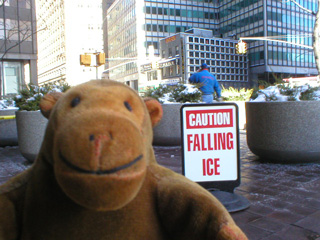 Mr Monkey beside a Falling Ice warning sign